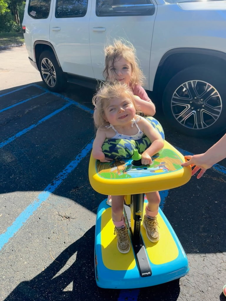 Emmy on an adaptive ride-on bike